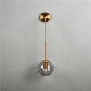 Modern brass glass ball wall lamp bedroom amber globe lighting by Decorbites