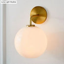 GobekUsa Modern Glass Orb Wall Sconce with Brass Arm, Clear/White
