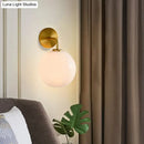 GobekUsa Modern Glass Orb Wall Sconce with Brass Arm, Clear/White