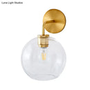 GobekUsa Modern Glass Orb Wall Sconce with Brass Arm, Clear/White