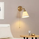 Modern brass wall lamp with frosted glass shade for bedroom reading by Decorbites