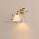 Modern brass wall lamp with frosted glass shade for bedroom reading by Decorbites