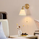 Modern brass wall lamp with frosted glass shade for bedroom reading by Decorbites