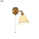 Modern brass wall lamp with frosted glass shade for bedroom reading by Decorbites