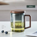 Modern glass tea cup with wood handle for kitchen drinking by Decorbites