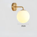 Modern gold and black led glass ball wall lights for bedroom by Decorbites