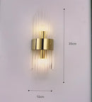 Modern gold crystal wall lamp for bedroom with vertical glass tubes by Decorbites
