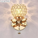 GobekUsa Globe Cutout Metal Shade Crystal Wall Sconce in Gold with Dropped Crystal Ball Accent