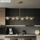 GobekUsa Sleek and Elegant Linear Gold Island Pendant Lighting with Spherical Glass Shades for Dining Table