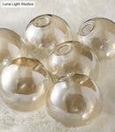 GobekUsa Mid-Century Modern Gold Metal Pendant with Spherical Amber Glass - Island Ceiling Light for Dining Table