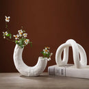 Modern white ceramic infinity symbol vase living room decor by Decorbites
