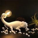 Modern white resin chameleon led table lamp for bedroom reading by Decorbites