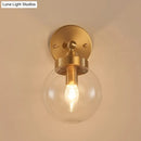 GobekUsa Rotatable Bedroom Wall Lamp in Brass with Clear Glass and Modernist Ball Design