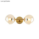 GobekUsa Modernist Gold Wall Lamp with Clear Glass Shade - 2 Lights Spherical Mount Fixture