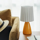 Orange ceramic milkshake bedside lamp with pleated shade for bedroom by Decorbites