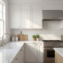 Modern kitchen with white cabinets, marble countertops, and stainless steel appliances. Palia White Dolomite Mosaic Tile 2"x 2" on 12" x 12" Mesh - Polished