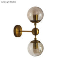 GobekUsa Post Modern Amber Glass Globe Wall Sconce with Brass Mount - 1/2 Light