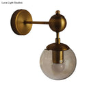 GobekUsa Post Modern Amber Glass Globe Wall Sconce with Brass Mount - 1/2 Light