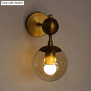 GobekUsa Post Modern Amber Glass Globe Wall Sconce with Brass Mount - 1/2 Light