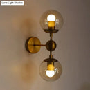 GobekUsa Post Modern Amber Glass Globe Wall Sconce with Brass Mount - 1/2 Light