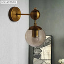 GobekUsa Post Modern Amber Glass Globe Wall Sconce with Brass Mount - 1/2 Light