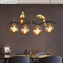 GobekUsa Postmodern Iron Pendant Light with 4-Lights, Black/Gold Finish, Amber Ball Glass Shade, Bird Deco - Sprig Island