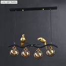 GobekUsa Postmodern Iron Pendant Light with 4-Lights, Black/Gold Finish, Amber Ball Glass Shade, Bird Deco - Sprig Island