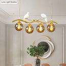 GobekUsa Postmodern Iron Pendant Light with 4-Lights, Black/Gold Finish, Amber Ball Glass Shade, Bird Deco - Sprig Island