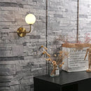 Retro brass curved wall lamp with clear glass ball for bedroom by Decorbites