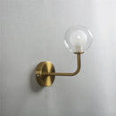 Retro brass curved wall lamp with clear glass ball for bedroom by Decorbites