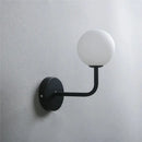 Retro brass curved wall lamp with clear glass ball for bedroom by Decorbites