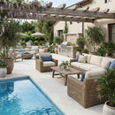 Outdoor patio with wicker furniture, pool, and pergola Shell Stone White Tumbled Limestone Pavers