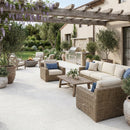 Outdoor patio with wicker furniture, pergola, and potted plants Shell Stone White Tumbled Limestone Pavers
