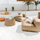 Outdoor patio with wicker furniture, cushions, and a umbrella on a white tiled floor. Shell Stone White Tumbled Limestone Pavers