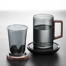 Sleek dark gray double walled glass tea cup with wooden lid kitchen by Decorbites
