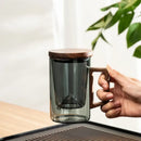 Sleek dark gray double walled glass tea cup with wooden lid kitchen by Decorbites