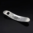Sleek stainless steel garlic press with integrated spoon kitchen tool by Decorbites