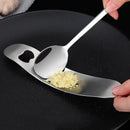 Sleek stainless steel garlic press with integrated spoon kitchen tool by Decorbites