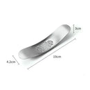 Sleek stainless steel garlic press with integrated spoon kitchen tool by Decorbites