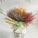 Vibrant multicolored dried flower bouquets in white vase living room by Decorbites