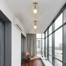 Vintage gold metal cage pendant light for restaurant and bar by Decorbites