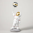 White and gold astronauts figurines with balloons living room decor by Decorbites