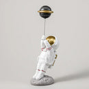 White and gold astronauts figurines with balloons living room decor by Decorbites