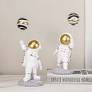 White and gold astronauts figurines with balloons living room decor by Decorbites