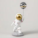 White and gold astronauts figurines with balloons living room decor by Decorbites