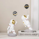 White and gold astronauts figurines with balloons living room decor by Decorbites