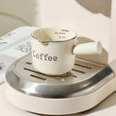 White ceramic espresso measuring cup and milk pitcher kitchen decor by Decorbites
