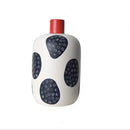 White ceramic polka dot vase with colorful graffiti lines living room by Decorbites
