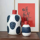 White ceramic polka dot vase with colorful graffiti lines living room by Decorbites