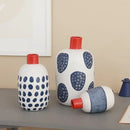 White ceramic polka dot vase with colorful graffiti lines living room by Decorbites
